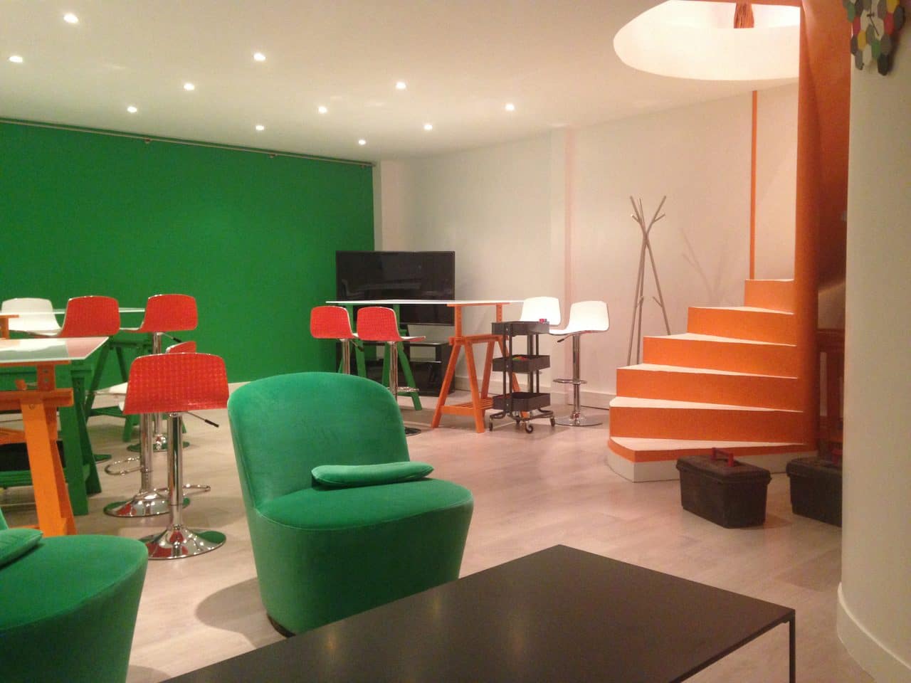 Création d’un espace de co-working à Courbevoie : espace de travail : table avec chaises hautes et fauteuils confortables