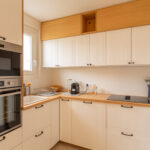 Rénovation d'un appartement à Pléneuf-Val-André (22) - cuisine blanche et bois avec des rangements